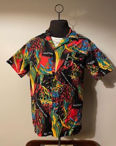 Vintage Hawaiian Shirt  - 100% cotton  - All over print design - Volcano graphic  - Abstract style art  - 70s/80s vintage  Size: L  Great vintage condition  No rips or holes  No stains Collared Cotton Hawaiian Shirt With All-over Print, Patterned Graphic Print Hawaiian Cotton Shirt, Patterned Cotton Hawaiian Shirt With Graphic Print, Patterned Graphic Print Cotton Camp Shirt, Patterned Cotton Camp Shirt With Graphic Print, Cotton Camp Shirt With All Over Print, Retro Cotton Tops With Graffiti Print, Multicolor Cotton Hawaiian Shirt With All Over Print, Spring Patterned Hawaiian Shirt With Graphic Print