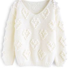 a white sweater with flowers on it