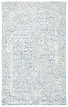 a blue and white rug with an intricate design