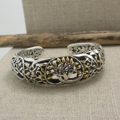 "Petite Tree of Life Bangle in Sterling Silver with 18K Accents. 2\" across a little less than a size 6 Front of Bracelet 5/8\"  Delicate Trees to the ends of the bangle. Nicely boxed for gift-giving with silver cloth Hinge opening. Keith Jack Jewelry Ships in 3 to 5 days. Ships Free within the USA 21 Day Returns Items must be returned in new unworn condition." Hallmarked Adjustable Cuff Bracelet For Gift, Adjustable Hallmarked Cuff Bracelet As Gift, Adjustable Hallmarked Cuff Bracelet Gift, Unique Hallmarked Bracelet For Gift, Gold Cuff Bracelet With Oxidized Finish Gift, Gold Oxidized Finish Cuff Bracelet Gift, Gold Bracelet With Oxidized Finish As A Gift, Symbolic Anniversary Jewelry Bracelet, Symbolic Anniversary Bracelet