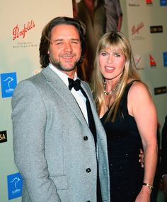 a man and woman standing next to each other on a red carpet at an event