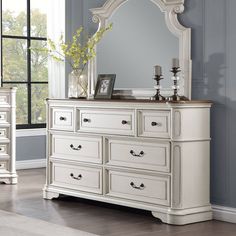 Classic design elements never go out of style the Florian collection is designed for the traditional home. The antique white finish gives off the right amount of distressing for a worn-in feel. Case goods offer a natural wooden finish for contrast against the antique white finish. The dresser includes a safety stop mechanism, which prevents the drawers from being fully pulled out and ensures that they remain securely in place. This feature adds an extra layer of safety, especially if there are c White Dresser With Brown Top, Master Dresser Decor, White Painted Dressers, Cream Dresser, China Cabinet Redo, Antique White Furniture, Antique Bedroom Furniture, Redo Cabinets, College Room