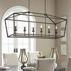 a chandelier hanging over a dining room table