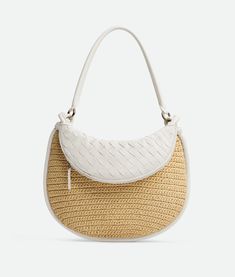 "Find BOTTEGA VENETA Medium Gemelli on Editorialist. Medium raffia crochet and Intrecciato leather shoulder bag. Tubular detachable handle. Additional half-moon zipped handle in Intrecciato leather. One internal zipped pocket. Zip closure. Lining: Canvas. Color: Natural/Chalk. Hardware: Brass finish. Height: 25 cm | 9.8\". Width: 36 cm | 14.2\". Depth: 10 cm | 3.9\". Handle drop: 26 cm | 10.2\". Viscose." Raffia Crochet, Crochet Shoulder Bag, Jewelry Knots, Leather Denim, Bottega Veneta Shoulder Bag, Mini Crossbody, Long Wallet, Half Moon, Accessories Necklace