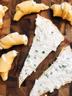 several pieces of cheese sitting on top of a wooden cutting board