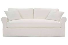 a white couch with pillows on it