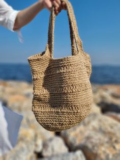 Discover Eco-Friendly Handmade Jute Beach Bag, perfect for summer vacations, this stylish and useful beach bag features a lining for added protection and large capacity to carry your family's essentials. Made from sustainable jute, it combines eco-friendliness with functionality,, making your beach days more enjoyable and organized. Model: Handmade Jute Beach/Everyday Bag Size: 30cm Height - 35 cm Width - Bottom 30 cm radius Material: Eco-Friendly Jute Rope Desing: Sustainable Summer Stylish Use Sand-colored Straw Bag For Summer Beach, Lightweight Beige Crochet Bag For Beach Season, Beige Lightweight Crochet Bag For Beach Season, Beachy Sand-colored Straw Bag, Beige Crochet Bag For Beach Season With Large Capacity, Beige Crochet Bag Large Capacity For Beach Season, Lightweight Beige Crochet Bag For Beach, Trendy Beige Crochet Bag For Beach, Trendy Beige Crochet Beach Bag