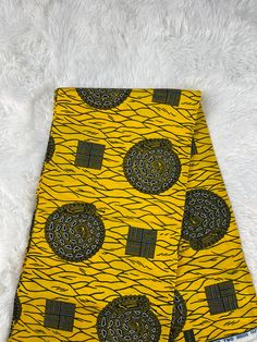 a yellow and black african print fabric