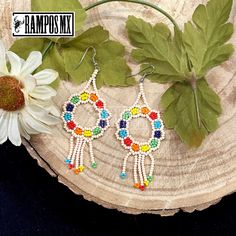 Beautiful Handmade Mexican Earrings , Mexican Shakira Earrings , Bohemian Boho earrings. 100% Handmade Handcraft by great Artisans in Mexico , These lovely Ear Wire earrings are extremely light and can be worn on all everyday occasions specially if you like colorful and fresh accessories. Aprox Size : 3 1/4 inches length & 1 3/8 inch wide Every piece is unique and color might change a little , depending on the screen device its been viewed on Aretes Mexicanos de Shakira , hecho a mano , Arte for Beaded Flower Dangle Earrings For Festivals, Dangle Flower Earrings With Ear Wire For Festival, Colorful Bohemian Beaded Earrings With Dangling Beads, Colorful Bohemian Dangle Beaded Earrings, Festival Flower Dangle Earrings With Beads, Bohemian White Flower Earrings With Colorful Beads, Bohemian Adjustable Flower Earrings With Colorful Beads, Adjustable Bohemian Flower Earrings With Colorful Beads, Bohemian Flower Earrings With Colorful Beads For Festivals