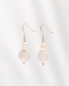 Elevate your style with the enchanting allure of our Freshwater Pearl Duo Earrings, meticulously handcrafted from sterling silver. Designed for those who appreciate elegance and versatility, these earrings epitomize timeless beauty. Each pair features genuine freshwater pearls, renowned for their lustrous charm and symbolism of purity. Features: Genuine Freshwater Pearls: Embrace the luxurious beauty of freshwater pearls, celebrated for their exquisite luster and natural elegance. Each earring s Pearl White Jewelry For Formal Occasions, Graceful Pearl Dangle Earrings, Classic Single Pearl White Earring, Delicate White Round Jewelry, Hypoallergenic Pearl Dangle Earrings, Timeless Sterling Silver Nickel-free Jewelry, Timeless Nickel-free Sterling Silver Jewelry, Classic Sterling Silver Single Earring, Delicate Round Pearl Earrings With Ear Wire