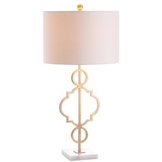 a table lamp with a white shade on the top and gold trimming around it