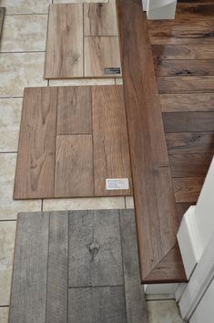 wood flooring samples are laid out on the floor next to each other in a kitchen