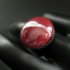 A richly colored dark red bit of rounded lampwork glass with a high gloss finish has been set upon a bronze tone adjustable ring base in this simple but elegant handmade ring design. Cabochon Size: approx. 18mm This handmade glass ring has an adjustable ring base that makes it comfortable to wear no matter the size of the wearer's fingers (size 7 and up) as well as ideal for switching from finger to finger as wanted. If you would like to order a larger quantity than what's offered in this listin Adjustable Vintage Ruby Ring, Vintage Adjustable Red Ruby Ring, Adjustable Oval Red Ruby Ring, Adjustable Red Oval Ruby Ring, Witch Rings, Red Ring, Easter Sale, Glass Ring, Bronze Ring