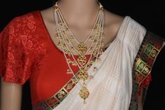 About the Jewellery  From fashion to jewelry, a resurgence of heritage styles is ruling bridal fashion right now, and nothing spells a royal bride more than these ornate layered necklaces. A symbol of nobility in the Deccan in ancient times, Panchladas (5-strand) and Satladas (7-strand) are regal necklaces crafted from pearls,  and other gemstones. This vintage style rani-haar's return to popularity can be credited to designer Sabyasachi Mukherjee. Today, these bold, yet classy necklaces can mak Elegant Temple Necklace For Diwali Marriage, Elegant Temple Necklace For Marriage And Diwali, Elegant Temple Necklace For Marriage During Diwali, Elegant Kundan Chandbali Necklace With Motifs, Elegant Bridal Necklace With Zari Work For Wedding, Elegant Bridal Necklace With Motifs For Wedding, Festive Bridal Necklace For Marriage, Traditional Cutdana Necklaces For Marriage, Elegant Heavy Temple Necklace For Marriage