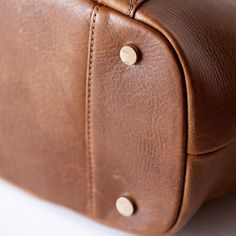 "A seasoned leather for every season of motherhood and womanhood. Tanned and finished with the finest oils and waxes, your bag reacts to your touch to reveal its complex coloring. Our New York leather factory tumbles and finishes each hide using Old World techniques and time-honored traditions. It is the same tumbling process as our deluxe leather but with a natural finish. Welcome to the unmatched quality of Lily Jade." The Shaylee converts to backpack or messenger carry in just seconds. Loving Lily Jade, Unicorn Bag, Your Touch, Love Lily, Leather Factory, Stroller Straps, Popular Bags, Accessories Packing, Natural Gold