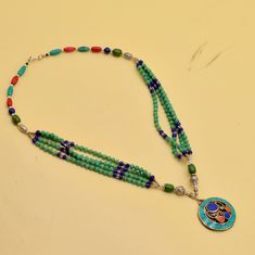 A very beautiful ethnic Necklace, it was handcrafted in Nepal. The design is inspired by traditional Nepalese pattern. The stones used for its manufacture are: Turquoise, Coral, Lapis Lazuli. Our products are totally handmade and made with high quality gemstones  If you believe in buying top quality products for yourself and for your family and friends,  Silverism is the place where you want to be There are unique pieces,  handcrafted to perfection with brilliant gem stones set in modern and traditional designs. We have jewelry for everyone,  Our collection also has some fabulous gifting ideas and we will gift wrap it specially for your special one too. Silverism brings you the widest array of jewelry at price points that will bowl you over. MESSAGE US FOR WHOLESALE PRICE ABOUT NEPALESE TI Handmade Temple Jewelry Beaded Necklaces For Festivals, Traditional Green Beaded Necklace For Festival, Artisan Green Beaded Necklaces For Festivals, Artisan Green Beaded Necklace For Festivals, Traditional Handmade Round Beaded Necklaces, Traditional Round Handmade Beaded Necklaces, Festive Multicolor Gemstone Beaded Necklaces, Festive Multicolor Gemstone Beads Necklace, Traditional Handmade Turquoise Beaded Necklaces