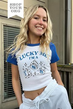 a woman with blonde hair wearing a white and blue shirt that says lucky all i'm a dice