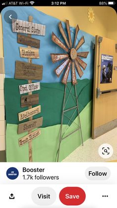 a classroom door decorated with wooden signs and windmill