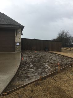 an empty yard in front of a house with no grass or dirt on the ground