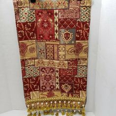 a red and gold tapestry hanging on a wall