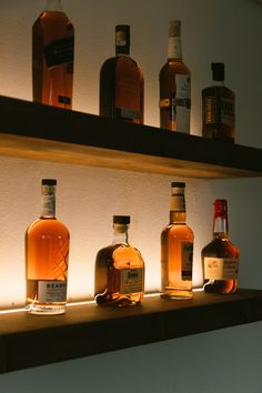 several bottles of whiskey are lined up on a shelf