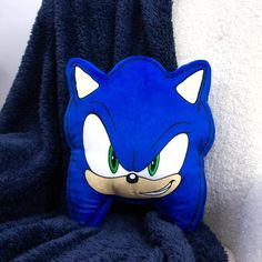 a blue pillow with an image of sonic the hedgehog's face on it