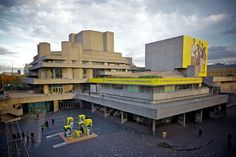 an aerial view of a large building with people walking around the courtyard and onlookers