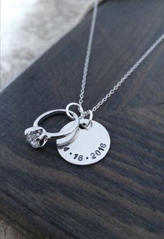 An adorable gift for her!   A 5/8 sterling silver disc is personalized with your anniversary date and hangs next to an engagement ring charm on an 18 sterling silver chain. Any important date of yours can be stamped on the necklace - wedding, engagement, first date! Please Personalized Round Pendant Jewelry For Anniversary, Personalized Jewelry For Anniversary With Round Pendant, Silver Jewelry With Engraving Option For Valentine's Day, Silver Stamped Necklaces For Anniversary Gift, Silver Stamped Necklace For Anniversary Gift, Hallmark Round Pendant Jewelry For Anniversary, Personalized Necklaces For Anniversary, Hand Stamped Silver Jewelry For Anniversary, Silver Hand Stamped Jewelry For Anniversary