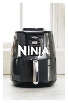 the ninja air fryer is black with white letters on it's front and side