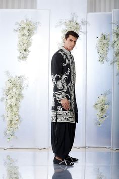 This black sherwani set features all over white dori embroidery on a thick matka silk base. This ensemble is paired with a black cotton silk kurta and a silk salwar. Completing footwear is also available.From Seema Gujral's Tuscan Summer collection. DELIVERY TIMEPlease allow 4 months for your outfit to arrive.FABRIC DETAILSThick Matka silkProfessional cleaning only. Designer Straight Kurta Sets For Ceremonies, Black Nehru Jacket With Zari Work, Black Kurta With Intricate Embroidery For Diwali, Designer Black Nehru Jacket With Chikankari Embroidery, Designer Embroidered Sherwani Kurta, Black Formal Kurta For Festivals, Formal Black Kurta For Transitional Season, Designer Black Sherwani With Dabka, Traditional Black Designer Salwar Kameez