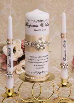 a wedding candle with two rings on it