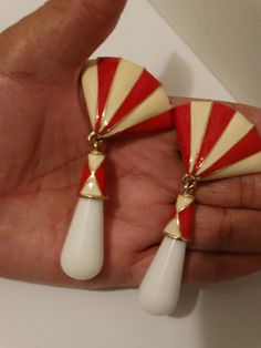 "The red and white enameled metal and plastic /Lucite dangling tier shape bottom size is 3 1/4\" inch tall x 1 3/4\" inch wide, 44.6 grams in weight in excellent vintage condition." White Enamel Jewelry For Party, Retro Red Dangle Earrings, Red Enamel Clip-on Jewelry, Red Enamel Clip-on Earrings, Retro White Dangle Earrings, Red Enamel Earrings For Party, Retro White Drop Earrings, Retro White Dangle Jewelry, Vintage Red Enamel Earrings