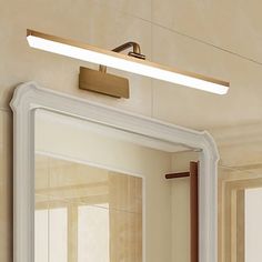 a bathroom mirror that has a light on it