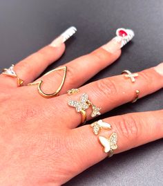 The Lorrie Rings - y2k gold adjustable wire butterfly and heart rings. A set of 5 trendy chic rings. 💕 Visit my shop for more listings xoxo https://www.etsy.com/shop/JennissiJewelry Y2k White Jewelry For Gift, Y2k White Jewelry Gift, Y2k Style White Jewelry For Gift, Trendy White Crystal Promise Ring, Trendy White Crystal Open Ring, Trendy White Midi Rings For Gifts, White Trendy Midi Rings As Gift, Trendy White Midi Promise Rings, Rings Y2k