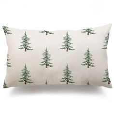 a white pillow with green trees on it