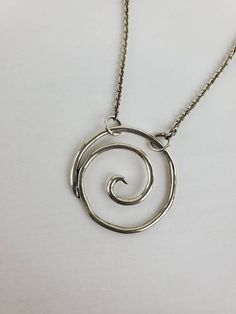 Sterling silver spiral pendant. Measures 1 1/4 x 1 1/4 inch. Has an attached 16 inch chain. Designed and handcrafted by Richelle Leigh using the lost wax casting process. Free shipping US. https://www.etsy.com/shop/RichelleJewelry Unique Spiral Sterling Silver Necklace, Spiral Sterling Silver Jewelry With Oxidized Finish, Nickel-free Sterling Silver Swirl Necklace, Hand Forged Silver Swirl Jewelry, Sterling Silver Swirl Necklaces, Hand Forged Silver Spiral Necklace, Spiral Hand Forged Sterling Silver Jewelry, Handmade Spiral Silver Necklace, Handmade Silver Spiral Necklace