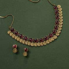 Description: This exquisite antique temple necklace embodies India's rich cultural legacy, showcasing a dazzling array of red kempu gemstones, layered with goddess Lakshmi embossed coins, enhancing the necklace's spiritual significance. Perfect for traditional occasions, this necklace exudes vintage sophistication. Details & Specification: Materials used: Brass Alloy with Antique Gold Plating Weight - Necklace- 53.75 gm, Earrings- 6 gm Length - Necklace-10 cm, Earrings-2 cm Make it custom: Want Kempu Necklace, Temple Necklace, Choker Pendant, Length Necklace, Diamond Necklaces, Goddess Lakshmi, Kundan Earrings, Kids Necklace, Green Beads