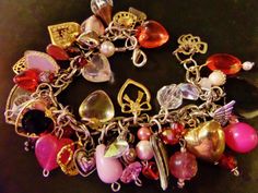 "This bracelet will make you feel \"charmed\" to be wearing it. It is a one of a kind item. The charms and beads used are vintage and new- combined. The colors are traditional pink, red, gold tone, and silver tone. Give this great item as a gift to a special friend or significant other, and they will be delighted. A sweethearts dream come true!" Pink Heart-shaped Beaded Bracelets With Charms, Heart-shaped Charms Beaded Bracelets For Jewelry Making, Multicolor Heart Charm Bracelet, Vintage Heart Charm Bracelet As A Gift, Vintage Charm Bracelet With Heart Charm, Vintage Heart Charm Bracelet For Gift, Handmade Metal Charm Bracelet For Valentine's Day, Vintage Heart-shaped Charm Bracelet For Valentine's Day, Handmade Vintage Bracelets For Valentine's Day