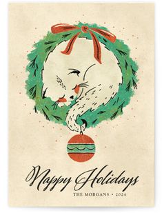 a christmas card with an image of a cat in a wreath and the words happy holidays