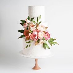 a white cake with pink flowers on top