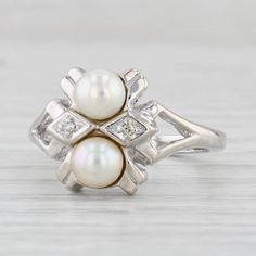 Gemstone Information: - Cultured Pearls - Size - 4.8 mm Cut - Round Bead Shape Color - White - Natural Diamonds Accents Metal: 14k White Gold  Weight: 4 Grams  Stamps: 14k Face Height: 11.9 mm  Rise Above Finger: 6.7 mm Band / Shank Width: 1.9 mm This ring is a size 4 3/4, but it can be resized up 3 sizes for a $30 fee. If you would like your ring resized, please select the appropriate fee from the listing below in order to pay the sizing fee: https://www.etsy.com/listing/781388346/ring-sizing-service-fee Each piece is thoroughly examined and refinished as needed by our professional jewelers, graded by our in-house GIA (Gemological Institute of America) Graduate Gemologist, and inspected for quality before being carefully packaged and promptly shipped. [SKU: B28686] phd Classic Multi-stone Diamond White Jewelry, Classic Multi-stone Jewelry In Diamond White, 14k White Gold Multi-stone Jewelry For Anniversary, Estate Style Round Jewelry Gift, Classic Round Multi-stone Jewelry, Platinum Multi-stone Jewelry For Anniversary, White 14k Gold Three-stone Jewelry, Classic Cluster Jewelry In 14k White Gold, Round Multi-stone Jewelry In 14k White Gold