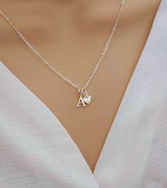 💖 Imagine the moment when you reveal this stunning initial & heart necklace... So pretty and absolutely gorgeous, she's sure to fall in love upon first glance!   💖 The most beautiful gift for yourself or someone special. Such a classy and elegant necklace she is sure to treasure forever. Delight her today with a precious and personalised gift.  Why Choose Our Initial & Heart Necklace? ✨ Elevate your style effortlessly ✨ A heartfelt gift that shows her how special she is ✨ Premium Quality Sterl Dainty Silver Heart Pendant Initial Necklace, Dainty Silver Initial Necklace For Valentine's Day, Mother's Day Sterling Silver Charm Necklaces, Mother's Day Sterling Silver Initial Pendant Charm Necklace, Mother's Day Silver Initial Pendant Necklace, Silver Necklace With Initial Pendant And Heart Charm, Valentine's Day Wedding Silver Initial Necklace, Heart Charm Initial Pendant Necklace Gift For Her, Silver Heart Initial Necklace For Valentine's Day