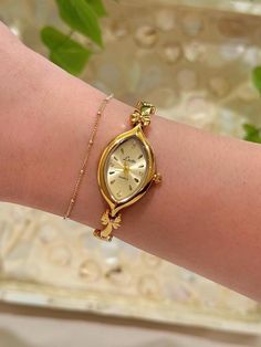 This gold tone vintage style quartz watch that has a unique watch face and dainty band. it's beautiful on and pair beautifully with other bracelets! - Length: 8 1/2 inches from one clasp to the other. - Works perfectly and has a new battery!  I suggest wiping it down with a soft cloth after each wear to ensure its longevity! Take a look at other beautiful watches here https://www.etsy.com/shop/vintagegirljewels?ref=seller-platform-mcnav As a small business, I'm unable to accept returns/refunds a Delicate Gold Watch Women, Vintage Watches Women Aesthetic, Vintage Dainty Watch, Dainty Watches, Dainty Gold Watch, Gold Watch Women, Unique Watches Women, Dainty Watch, Watch Minimalist