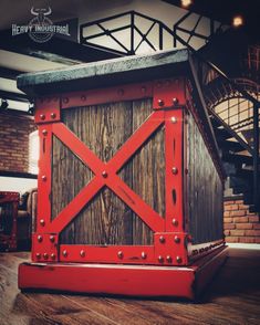 a red wooden structure sitting on top of a hard wood floor