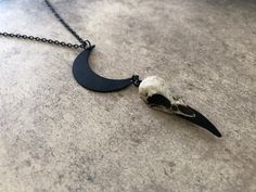 "This unique skull necklace is the perfect witchy gift for that hard to shop for friend, niece, sister or daughter. If you are looking for a one of a kind birthday gift for any lover of oddities, the occult, witchcraft, alchemy, alternative fashion or goth aesthetic... look no further! The little mini skull is hung from a black enameled crescent moon. *In stock and ready to ship from Minnesota in 1-3 days! Crescent Moon Raven Skull Lunar Necklace - Waning Moon Necklace with a 1.5\" (3.81cm) resi Bohemian Necklace For Halloween Gift, Black Skull Necklace For Halloween, Halloween Moon Charm Jewelry As Gift, Witchy Moon Phase Jewelry Gift, Gothic Round Pendant Necklace For Halloween, Handmade Gothic Moon Shaped Jewelry, Spooky Skull Jewelry For Gifts, Black Moon Charm Jewelry For Halloween, Unique Nickel-free Necklaces For Halloween