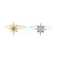 two gold and silver rings, one with a star on the middle set against a white background