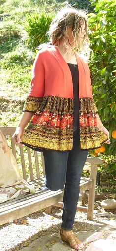 a woman standing next to a wooden bench