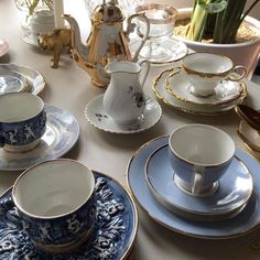 a table topped with lots of blue and white dishes