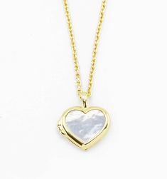 One of our favorite materials makes it way onto our heart charm. Then we transformed it into a precious locket. Fill it with mini portraits, a small piece of your wedding dress, or... secrets - it's up to you! We love how you can wear this as a personal reminder or fashion statement. Note, this locket is also double-sided with blue lapis on the back!
Length: 20"-2"Pendant size: 14mm Elegant Locket Necklace With Heart And Initial Pendant, Elegant Heart Necklace For Keepsake, Charm Heart Pendant Jewelry For Weddings, Heart Pendant Charms Jewelry For Wedding, Heart Charm Pendant Jewelry For Wedding, Elegant Heart Locket Charm Necklace, Elegant Heart Shaped Locket Charm Necklace, Elegant Heart-shaped Charm Necklace For Keepsake, Elegant Heart-shaped Locket Charm Necklace