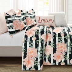 a black and white bed with pink flowers on it